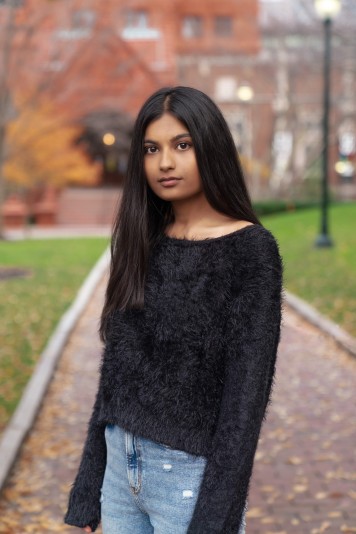 Young woman with long dark hair and black sweater 